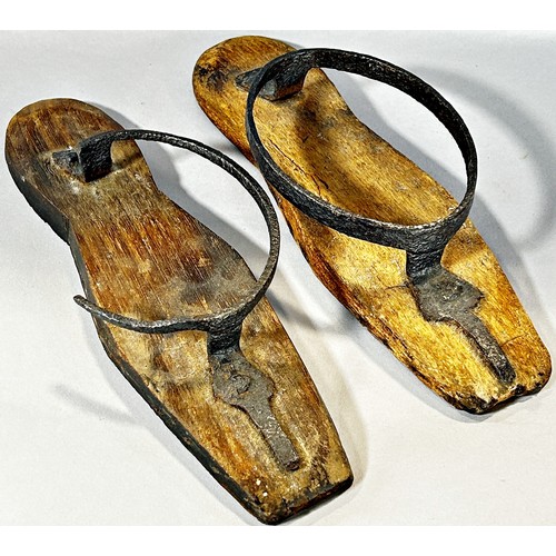 500 - A pair of 18th century iron and wood mud boots, lacking leather straps, (one as found) 25cm long.