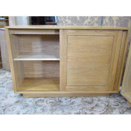 1242 - Three contemporary Ercol cabinets with sliding panelled doors, each cabinet 86cm high x 130cm wide x... 