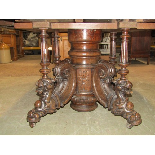 1243 - A Large Victorian oak D end dining table, raised on a central pillar with scroll and lion detail, wi... 