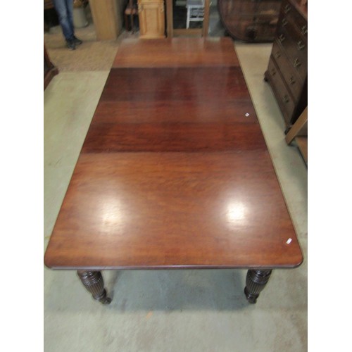 1244 - A good quality Victorian mahogany extending dining table raised on four turned and fluted supports, ... 