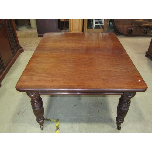 1244 - A good quality Victorian mahogany extending dining table raised on four turned and fluted supports, ... 