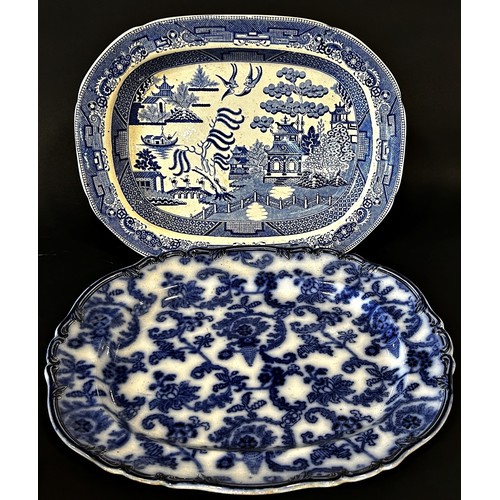 133 - A large Rhine pattern meat plate with gravy well and drainer, and five other blue and white meat pla... 