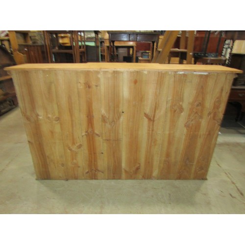 1246 - A 19th century stripped and waxed pine breakfront cabinet, the central door flanked by two glazed pa... 