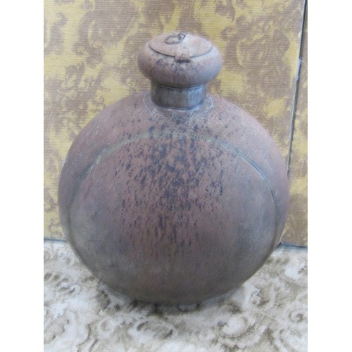 1247 - A large Indian circular metal work ‘moon’ flask with hinged cover, 70cm high