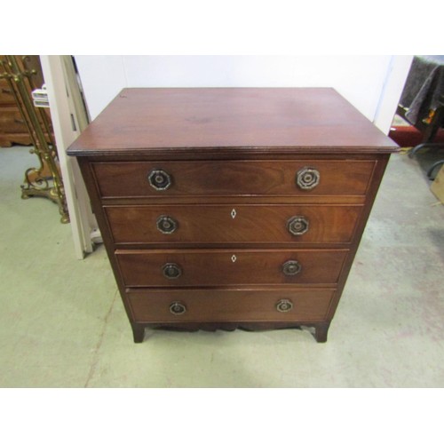 1250 - A small Regency mahogany and oak lined chest of four long graduated drawers, with brass plate handle... 