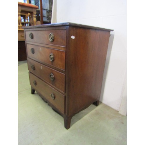 1250 - A small Regency mahogany and oak lined chest of four long graduated drawers, with brass plate handle... 