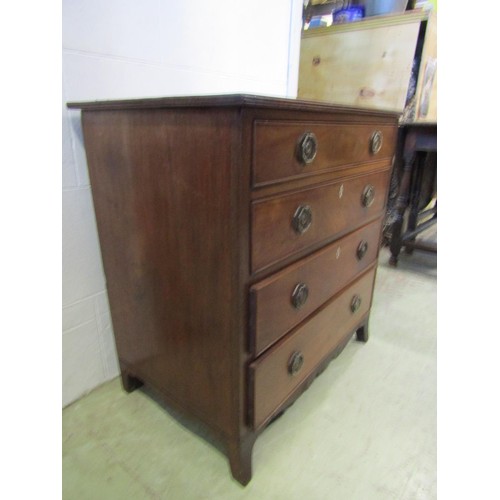 1250 - A small Regency mahogany and oak lined chest of four long graduated drawers, with brass plate handle... 