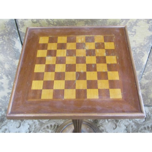 1252 - A games table with chequered board top on fluted column supports