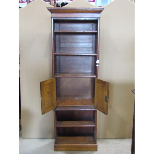 1259 - An Edwardian oak bookcase fitted with an arrangement of open shelves and two central doors, 174cm hi... 