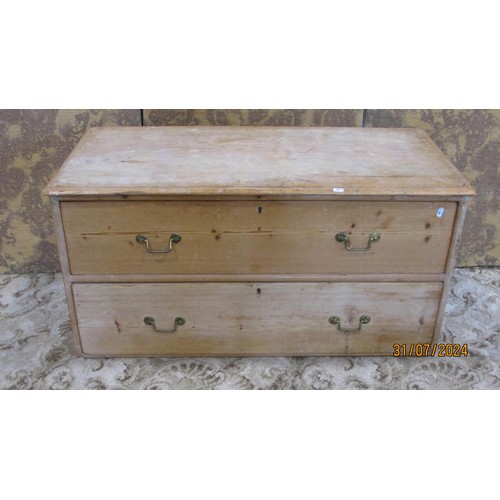 1212 - A low stripped pine chest with two long drawers 106cm w x 53cm h x 50cm d.