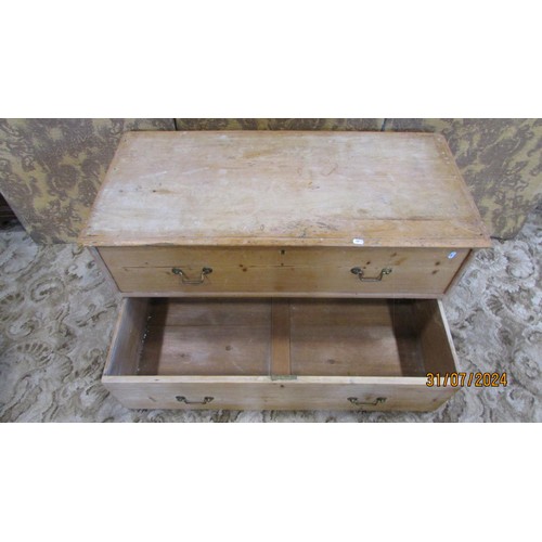 1212 - A low stripped pine chest with two long drawers 106cm w x 53cm h x 50cm d.