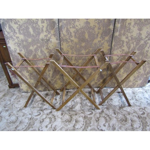 1205 - Three similar Butler’s woven cane trays / occasional tables, all with folding stands, with labels Ta... 