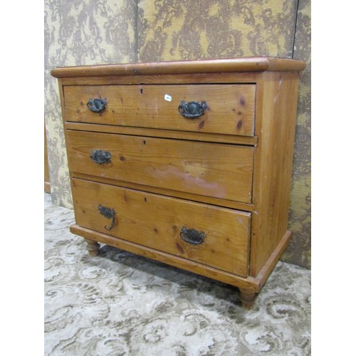 1213 - An old pine chest with three graduated long drawers raised on turned supports, 85cm w x 81cm h x 41c... 