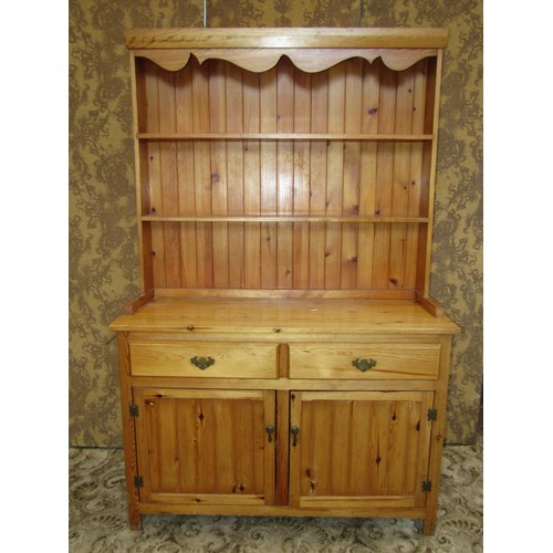 1206 - A small pale pine kitchen dresser with associated enclosed Delft rack above a pair of drawers and pa... 