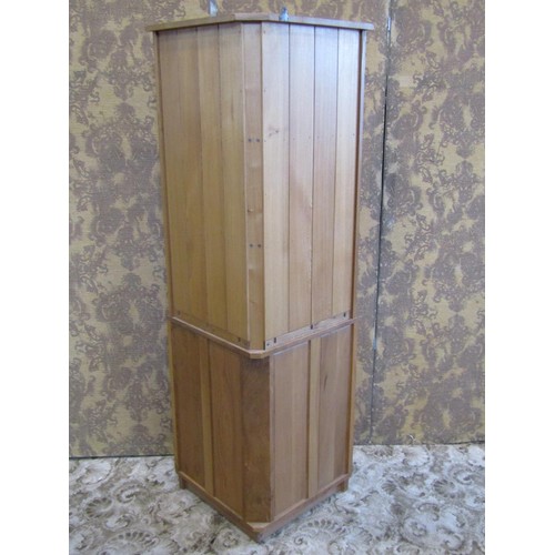 1209 - A pale Ercol floor-standing corner cupboard with open shelves over a cupboard base with hinged panel... 