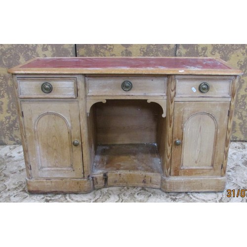 1215 - A 19th century pine kneehole writing desk with leather top with a row of three drawers with cupboard... 