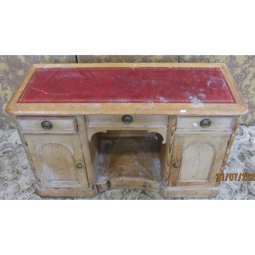 1215 - A 19th century pine kneehole writing desk with leather top with a row of three drawers with cupboard... 