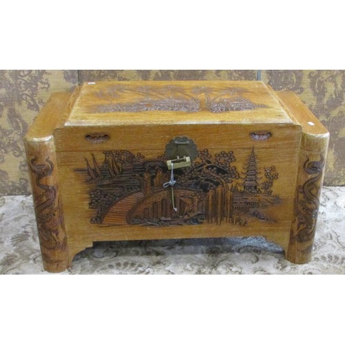 1218 - A Chinese intricately carved camphor wood trunk, 93cm wide.