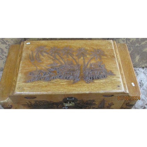 1218 - A Chinese intricately carved camphor wood trunk, 93cm wide.