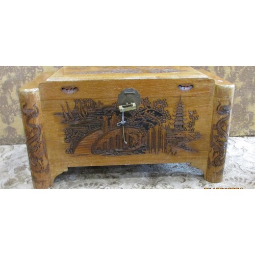 1218 - A Chinese intricately carved camphor wood trunk, 93cm wide.