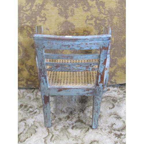 1261 - A miniature painted and scraped teak bergere caned child’s elbow chair, together with a bamboo candl... 