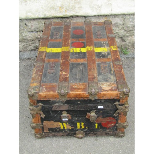 1264 - A vintage travel trunk with leather bands and metallic borders