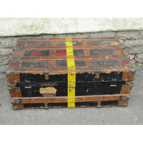 1264 - A vintage travel trunk with leather bands and metallic borders