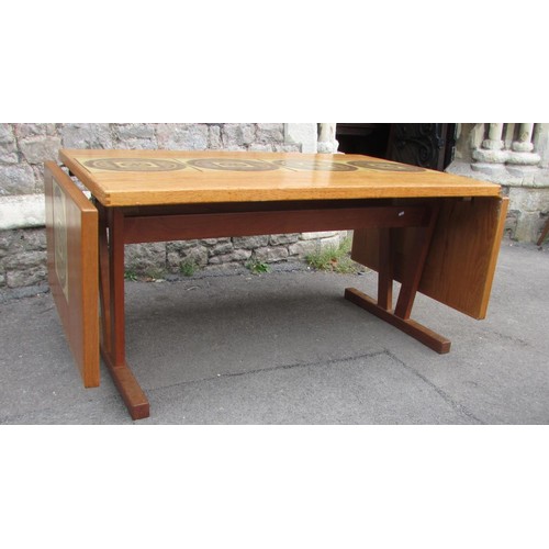 1230 - A G plan teak extending dining table with a central row of six tile coasters and six spindle back ch... 