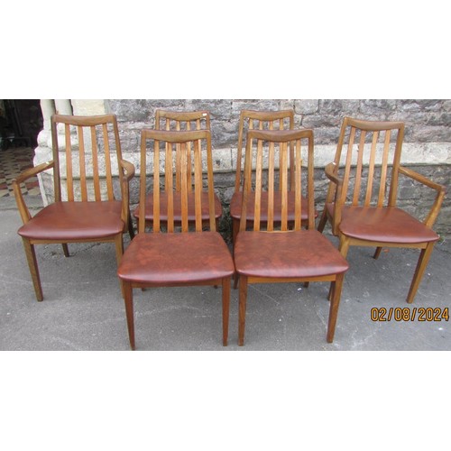 1230 - A G plan teak extending dining table with a central row of six tile coasters and six spindle back ch... 