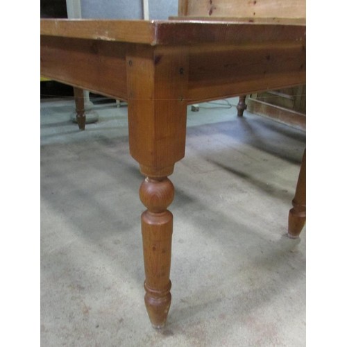 1232 - A large contemporary pine kitchen table on for turned supports, 142cm x 93cm.