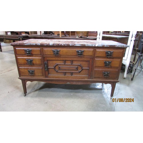 1269 - An Art Nouveau washstand in oak with enclosed front beneath a marble top (top af)