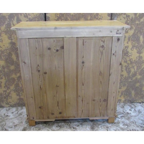 1274 - A 19th century stripped and waxed pine side cupboard enclosed by two panelled doors with two drawers... 