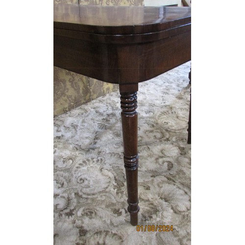 1279 - A 19th century mahogany D end foldover top card table on turned supports