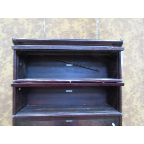 1283 - An Edwardian mahogany four tier Globe Wernicke bookcase, raised on base section, each tier with badg... 