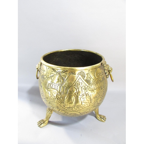 545 - A large continental brass jardiniere/coal pail of cauldron form, raised on three lion paw supports w... 