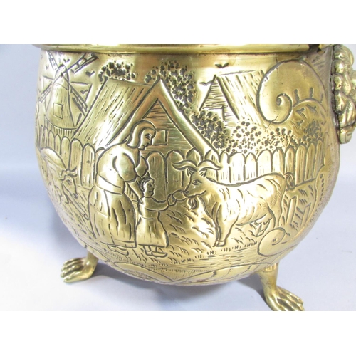 545 - A large continental brass jardiniere/coal pail of cauldron form, raised on three lion paw supports w... 