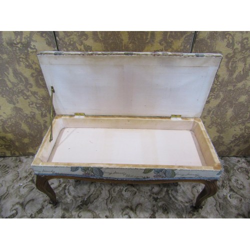 1253 - A 19th century French ottoman stool raised on scrolled supports, the box seat with rising upholstere... 