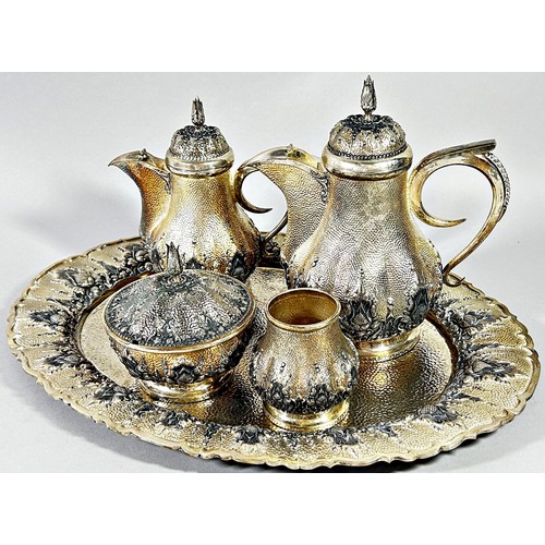 269 - An Indonesian silver Arabic style tea and coffee service with two pots, sugar bowl, a caddy bowl, si... 