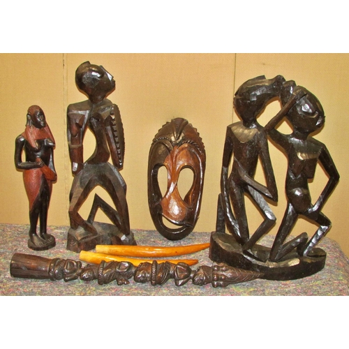 1165 - A large collection of decorative 20th century African export souvenir carvings to include masks, fig... 