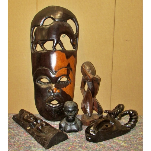 1165 - A large collection of decorative 20th century African export souvenir carvings to include masks, fig... 