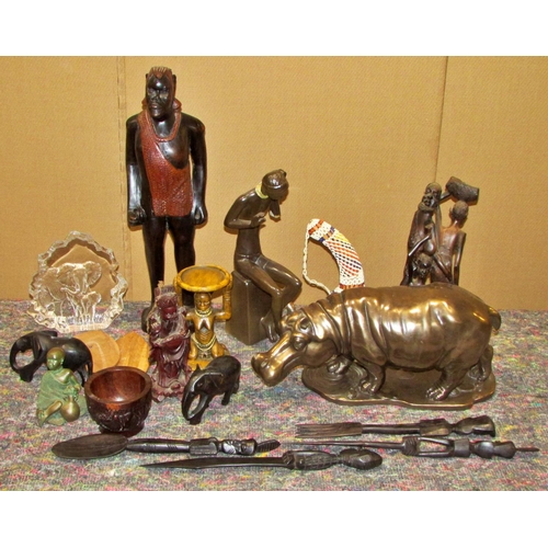 1165 - A large collection of decorative 20th century African export souvenir carvings to include masks, fig... 