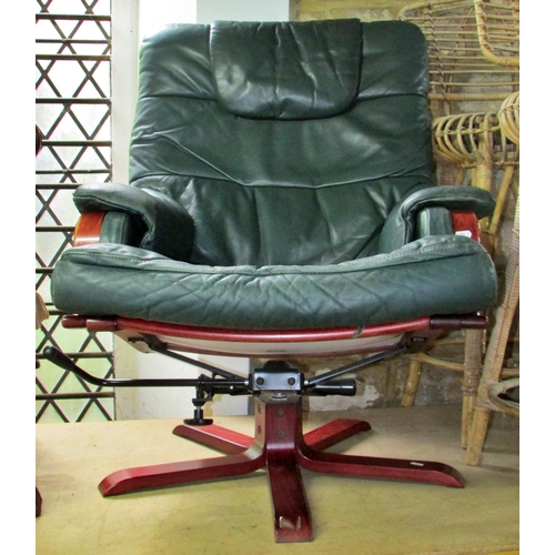 1177 - A Stressless type leather swivel lounge chair and matching foot stool