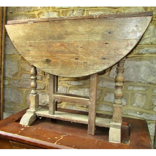 1185 - A primitive antique oak gateleg table of narrow proportions, together with a 19th century pine cover... 