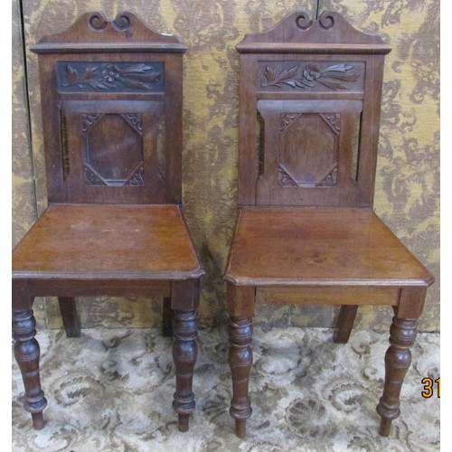 1310 - A pair of late Victorian walnut hall chairs in the Aesthetic Movement, with carved floral detail, ra... 