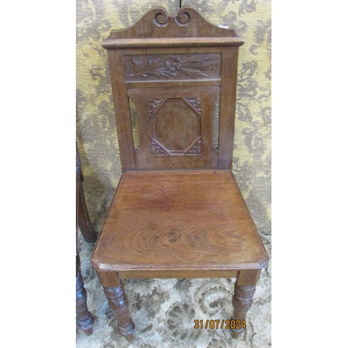 1310 - A pair of late Victorian walnut hall chairs in the Aesthetic Movement, with carved floral detail, ra... 