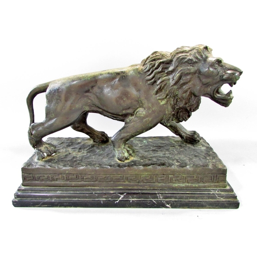 509 - A bronzed study of a male lion after Barye raised on a stepped marble plinth, 37cm wide x 26cm high.