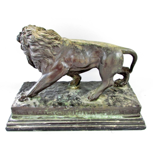 509 - A bronzed study of a male lion after Barye raised on a stepped marble plinth, 37cm wide x 26cm high.