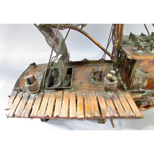 510 - A hand made model copper fishing boat attached to a quay, named Currie & Currie, 45cm long