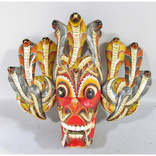 525 - A mixed selection of Sri Lankan and Balinese colourful carved masks, and a single mask Aztec Mayan m... 