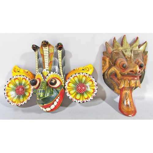 525 - A mixed selection of Sri Lankan and Balinese colourful carved masks, and a single mask Aztec Mayan m... 